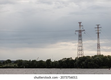  Pylons For The Transmission Of High Voltage Electricity From A Power Plant Near The Water. High Quality Photo