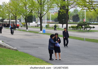 Pyongyang, North Korea - April 30, 2019: Street Scene. Two Older Women Are Reading A Message On A Smartphone And Laughing. The Street Ryomyong In New Residental Complex