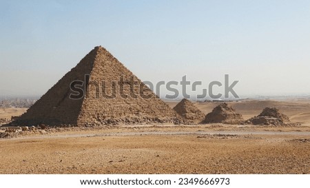 Pyramid, in architecture, a monumental structure constructed of or faced with stone or brick and having a rectangular base and four sloping triangular (or sometimes trapezoidal) sides meeting 
