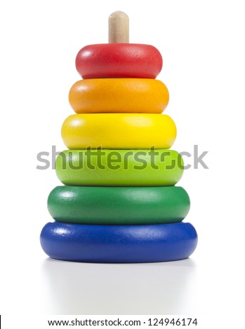 Pyramid build from colored wooden rings with a clown head on top. Toy for babies and toddlers to joyfully learn mechanical skills and colors. Studio shot on white background.