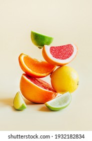 pyramid of citrus fruits grapefruit, orange, lemon, lime on yellow background
