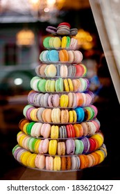 Pyramid of colorful macarons in a shop-window.