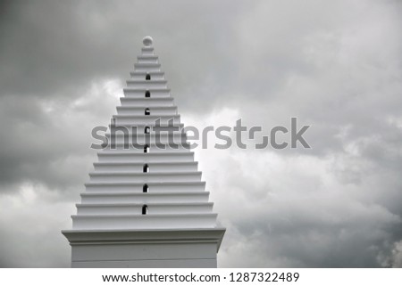 Pyramid Like Architectural Element With Stacked Steps Under Cloudy Sky In Alys Beach Florida