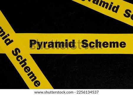 Pyramid scheme alert, caution and warning concept. Yellow barricade tape with word scam in dark black background.