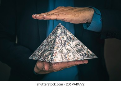 a pyramid scheme in the hands of a fraudster. The concept of exchange in financial markets is the collapse of the financial system of capitalism. - Shutterstock ID 2067949772