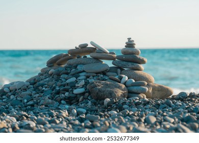 Pyramid of sea pebbles on a turquoise sea background - Powered by Shutterstock