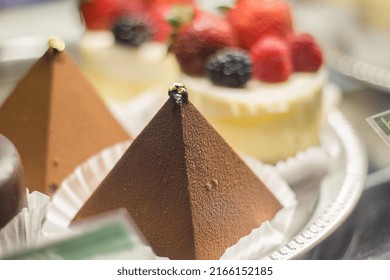 Pyramid shaped cake next to more cakes