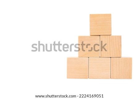 Pyramid of six wooden cubes, space for text. White isolated background.