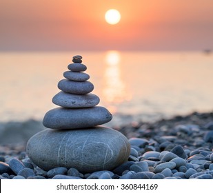 Pyramid Of Stones For Meditation Lying On Sea Coast At Sunset