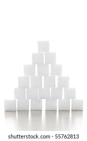 Pyramid Of White Sugar Cubes Stacked Up On White Background