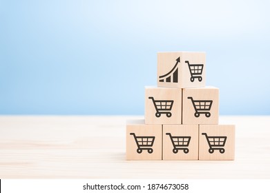 Pyramid Of Wooden Cubes With Sales Icons. Sale Volume Increase Make Business Grow Concept. Top Cube Of The Sales Pyramid With Icon Graph And Shopping Cart Symbol.