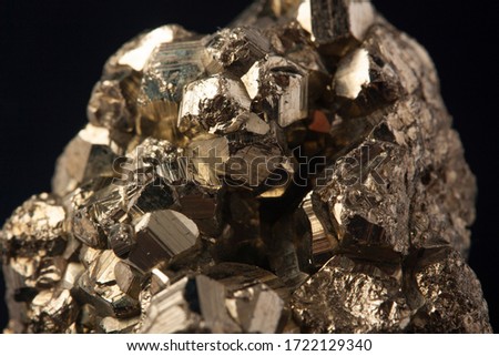 Pyrites crystals on the black background, macro, FeS2