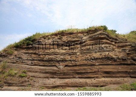 Pyroclastic deposit rock cliff - Due to ancient volcanic activity,
thick layers of sediment are formed along the coast of Jeju Island,
Korea