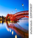 The Python Bridge, Amsterdam, the Netherlands. A bridge in the city at night. The bridge on the blue sky background during the blue hour. Architecture and design. 