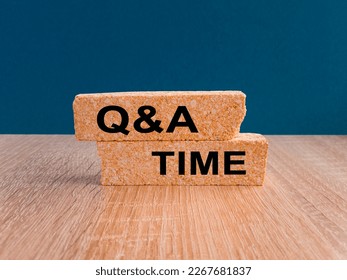 Q and A, questions and answers time symbol. Concept words 'Q and A time' on brick blocks on a wooden table, beautiful blue background. Business and Q and A time concept.