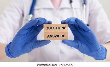 Q and A - Questions and Answers - inscription words sign on wooden block in doctor hands, medical questions concept
