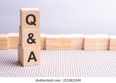 Q and A written in wooden cubes. business conceptual word collected of of wooden elements with the letters. Q and A - ahort for Question and Answer