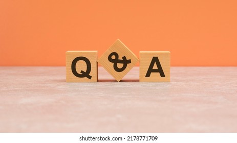 qa - acronym from wooden blocks with letters, questions and answers concept on orange background. copy space available. - Shutterstock ID 2178771709
