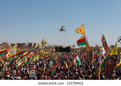 QAMISLO - MARCH 21: More Than 20,000 Kurds Celebrated Kurdish Festival Newroz. The Syrian Army Military Helicopter Flyed Over The Meeting On 21 March 2013 In Qamlo, Syria.