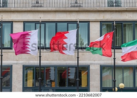 Qatar Bahrain Oman Flags in Front of Hotel Building Middle East