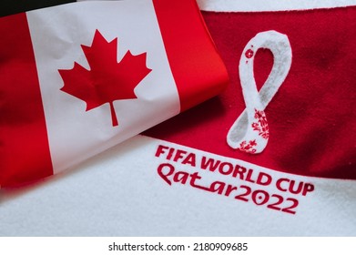 QATAR, DOHA, 18 JULY, 2022: Canada National Flag And Logo Of FIFA World Cup In Qatar 2022 On Red Carpet. Soccer Sport Background, Edit Space. Qatar 22 Wallpaper. National Symbol, Football Event