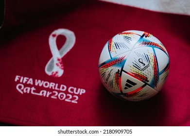 QATAR, DOHA, 18 JULY, 2022: Official Adidas World Cup Football Ball Al Rihla. And Logo Of FIFA World Cup In Qatar 2022 On Red Carpet. Soccer Sport Background, Edit Space. Qatar 22 Wallpaper.