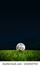 QATAR, DOHA, 5 OCTOBER, 2022: Official Fifa World Cup Football Ball Al Rihla. World Championship In Qatar 2022. Soccer Match Ball On Green Grass In Night. Vertical Photo. 