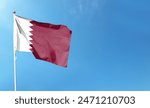 Qatar flag on cloudy sky. flying in the sky