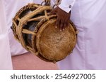 Qatari man drumming on old drums in traditional dance (Al Ardha).