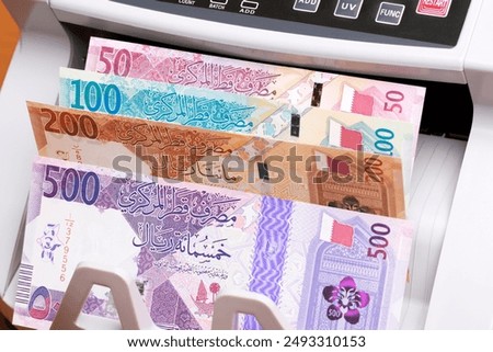 Qatari money - riyal in the counting machine