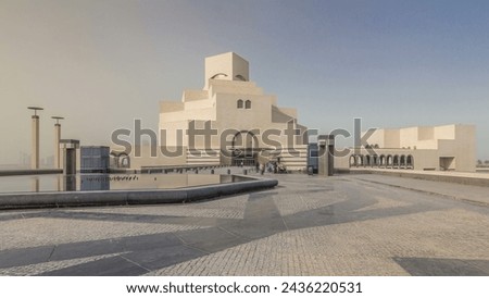 Qatar's museum of Islamic Art timelapse hyperlapse on its man-made island beside Doha Corniche, with dhows moored in the bay surrounding it. Front view with fountain