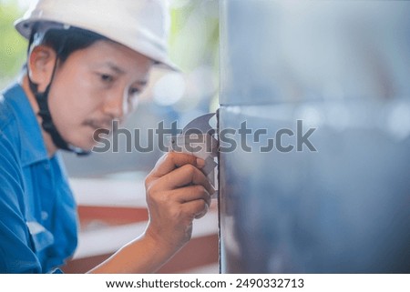 QC Technician inspector using welding gauge inspection butted weld on steel plate  structure in industry fabrication factory. NDT