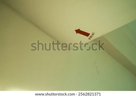 Qibla direction indicator installed on the ceiling of the hotel room