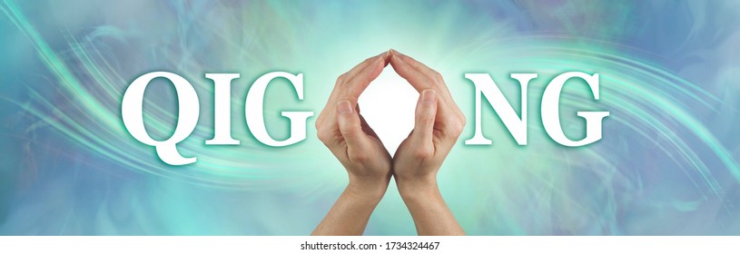 Qigong healing hands concept banner - female hands making the O of QIGONG against a jade green energy formation  background with white light behind the hands and copy space
