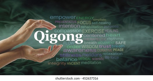 Qigong word cloud and healing hands - female cupped hands with the word QIGONG between surrounded by word cloud on a flowing green light and dark background