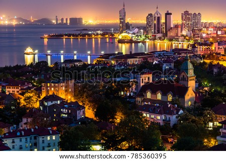 Qingdao Bay and the Lutheran church seen from the hill of Signal Park at night, Qingdao, China