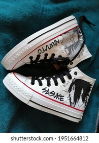 Qingdao, Shandong, China - April 13 2020: Naruto And Sasuke High Top Sneaker Shoes With Black Shoelaces And White Fabric Perfect For Gamer Girls, Sexy Geeks, And Cute Nerds.