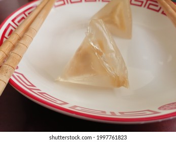 Qingdao, Shandong, China - June 06 2021: A closeup of two clear delicious crystal ice Zongzi dumplings from Starbucks on a plate to celebrate Chinese Dragon Boat Festival.
