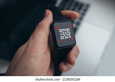 QR code concept. Clock with a symbol on the screen in the hands of the person