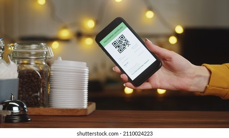 QR Code, Covid Vaccination Passport Control Close-up. Scanning Coronavirus Electronic Medical Certificate On Smartphone In Cafe Or Restaurant, Green Zone.