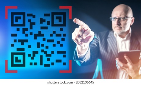 QR code near businessman. Modern business technology. QR code for identification or payment for services concept. Using QR key in your business. Man with tablet points his finger. Selective blurred