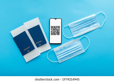 Qr code of negative covid test vaccination stamp on smartphone screen. Green pass certificate for airplane fly. Medical masks, passports plane tickets. Electronic Immunity passport tourism lockdown
