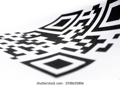 QR code on curled paper. Focus on the center of the code, shallow depth of field