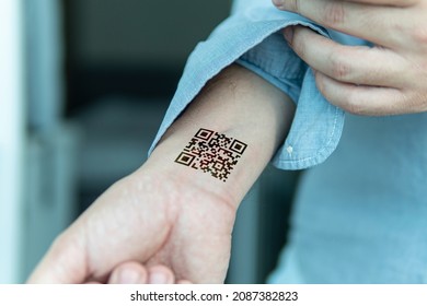 QR Code On The Person's Wrist. Concept Of Chipping A Person To Control Or Simplify The Work With Personal Data, Close-up.