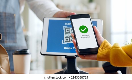 QR code payment, customer using smartphone for paying at shop - Powered by Shutterstock