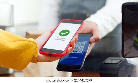 QR code payment, customer using smartphone for paying at shop