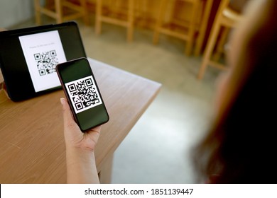 Qr code payment. E wallet. Woman scanning QR code online shopping cashless technology concept