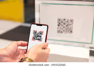 Qr Code Payment, E Wallet , Cashless Technology Concept. Man Scanning Tag Before Access Inside The Office Building. (Selective Focus)