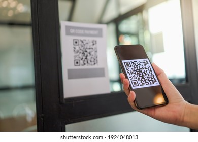 Qr code payment. E wallet. Man scanning tag accepted generate digital pay without money.scanning QR code online shopping cashless technology concept - Shutterstock ID 1924048013