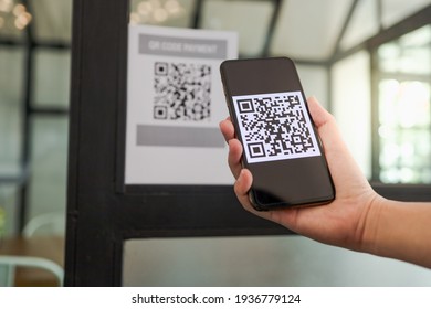 Qr code payment. E wallet. Man scanning tag accepted generate digital pay without money.scanning QR code online shopping cashless technology concept - Shutterstock ID 1936779124